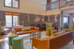 The cozy lobby of the inn at the summit, featuring comfortable seating and a warm fireplace.